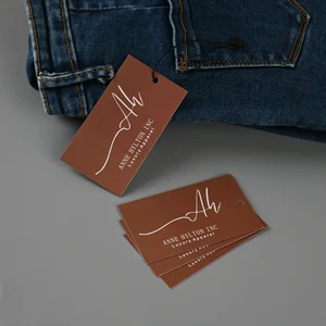 Étiquettes de marque pour vêtements présenté comme exemple de fabrication d étiquette textile avec étiquette cartonnée, étiquette de taille et écusson textile